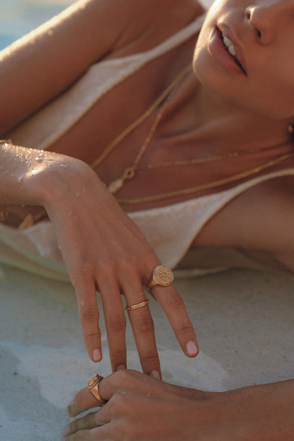 model wearing a Signet Ring lying down on ground 